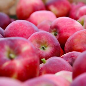 Close-up of bright red apples at a market in Fès, showcasing their freshness and vibrant color.
